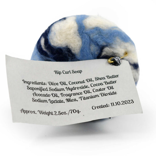 Blue and white felted soap bar with a label on a white background