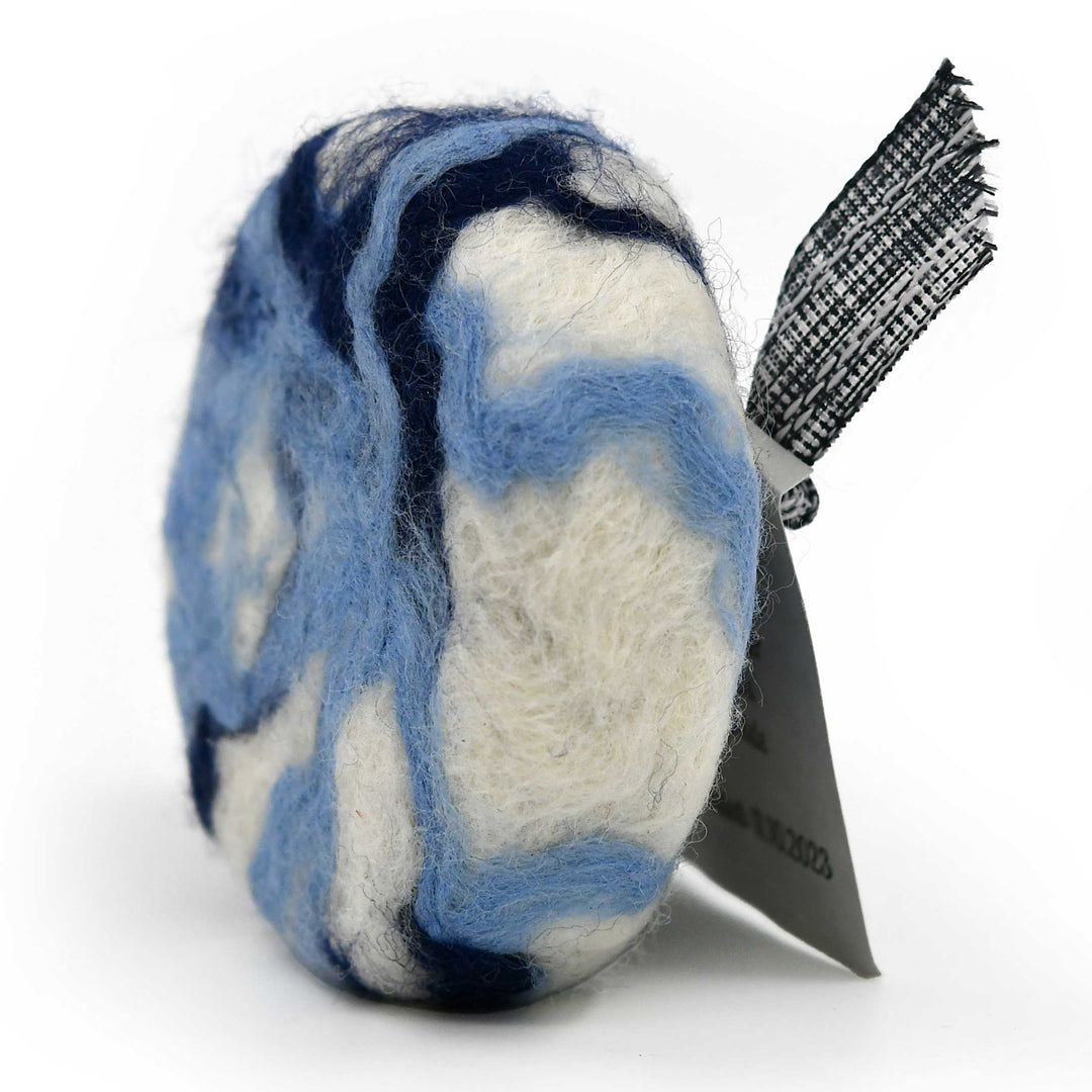 Marbled blue and white felted soap with a black ribbon on a white background