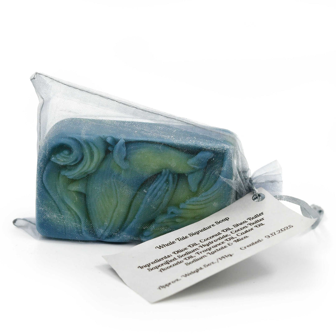 Blue and green soap bar in a clear plastic bag with a label on a white background