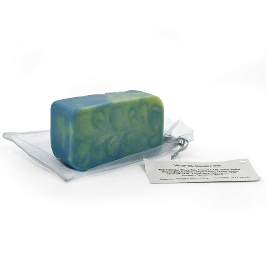 Green and blue soap bar on a white background with a label next to it.