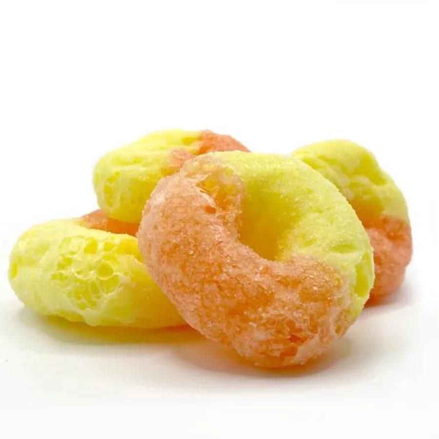 A pile of freeze dried peach rings on a white background