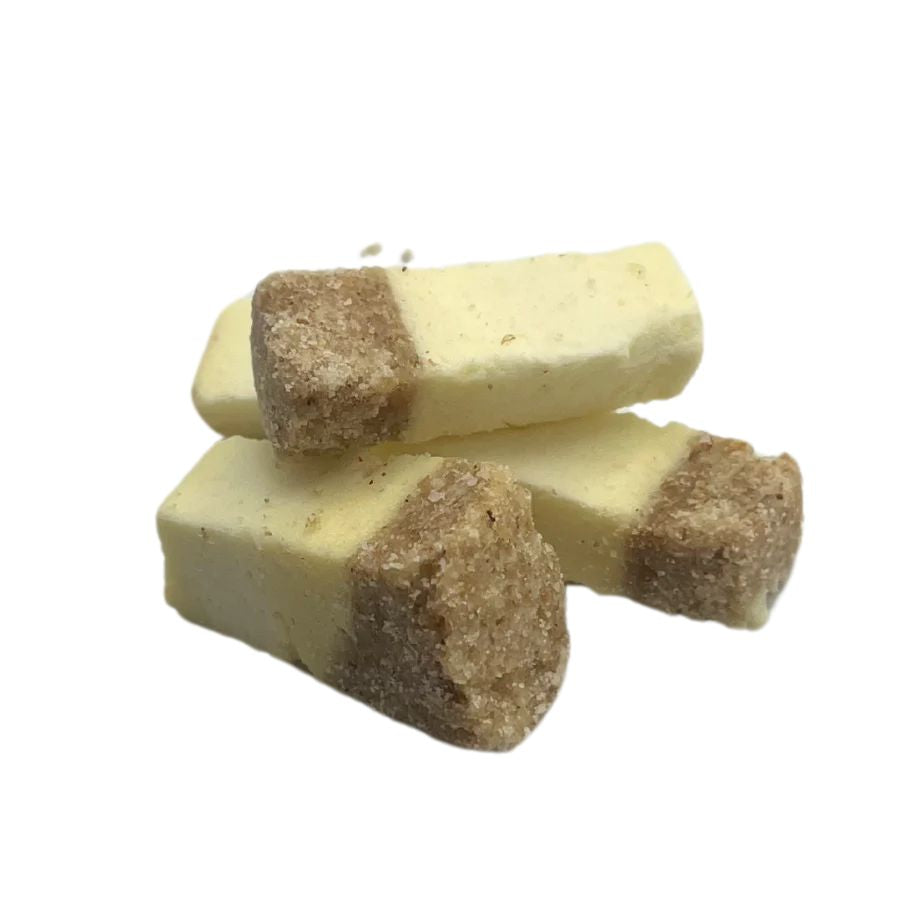 A pile of freeze dried cheesecake bites on a white background