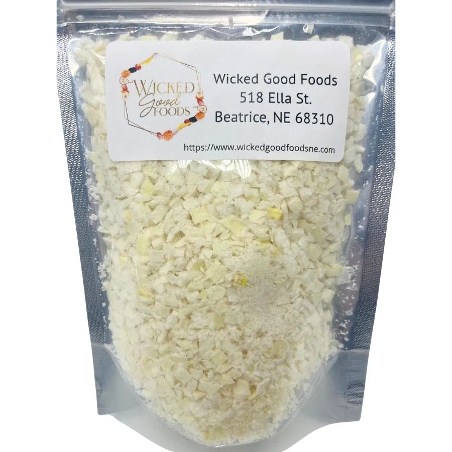 A close up of freeze dried Yellow Onions on a white background