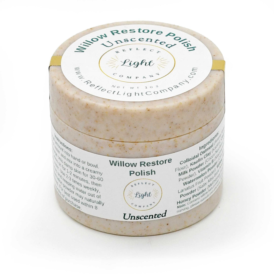 A round jar of Willow Restore Polish Unscented by Reflect Light Company, showing a textured beige polish inside and a white label with green and black text, wrapped in a gold band.