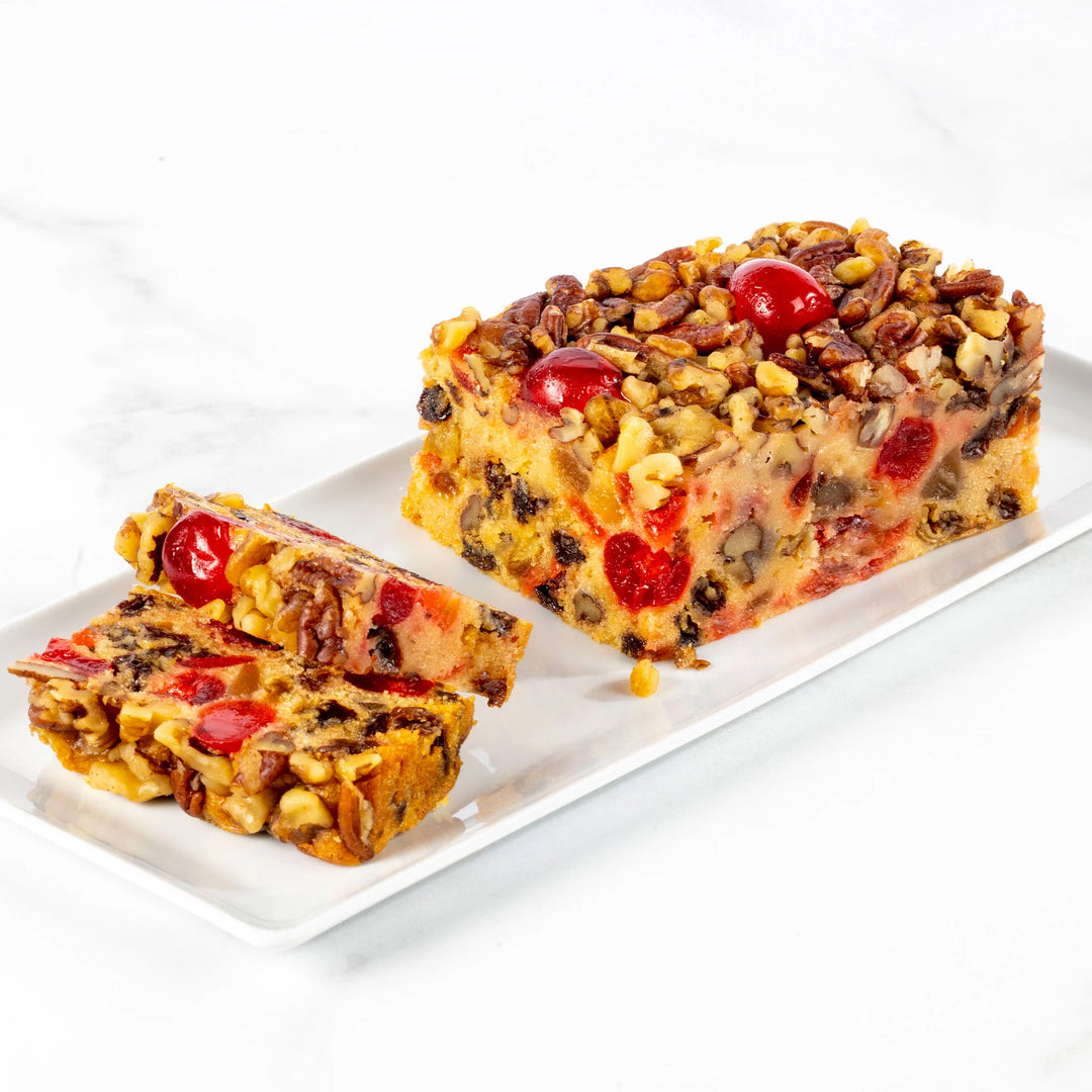 Fruitcake with cherries on a white plate