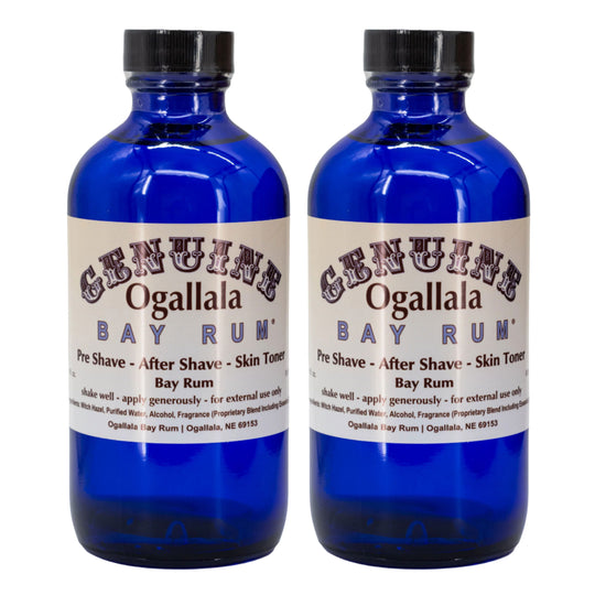 Two blue bottles of Ogallala Bay Rum on a white background