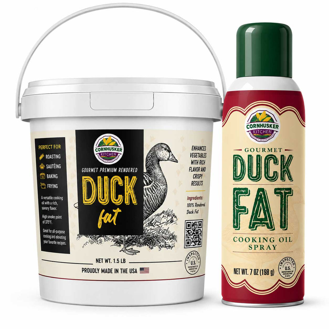 A white plastic bucket of Commisaires Gourmet Duck Fat alongside a matching red and green aerosol can of Duck Fat Cooking Oil Spray on a white background.