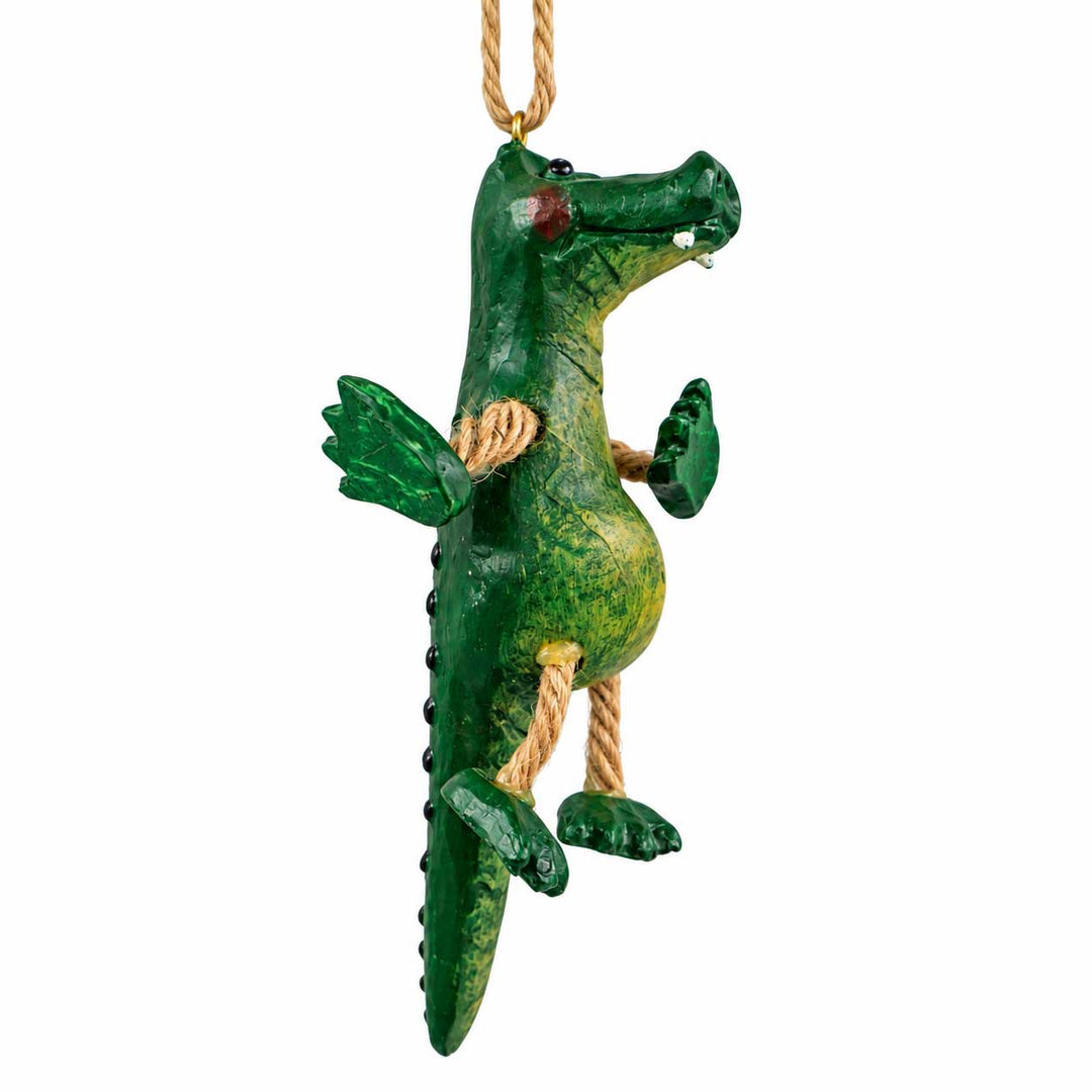 A green alligator hanging ornament with a textured painted finish, rope-wrapped limbs, and a natural jute hanging loop at the top, shown against a plain white background.