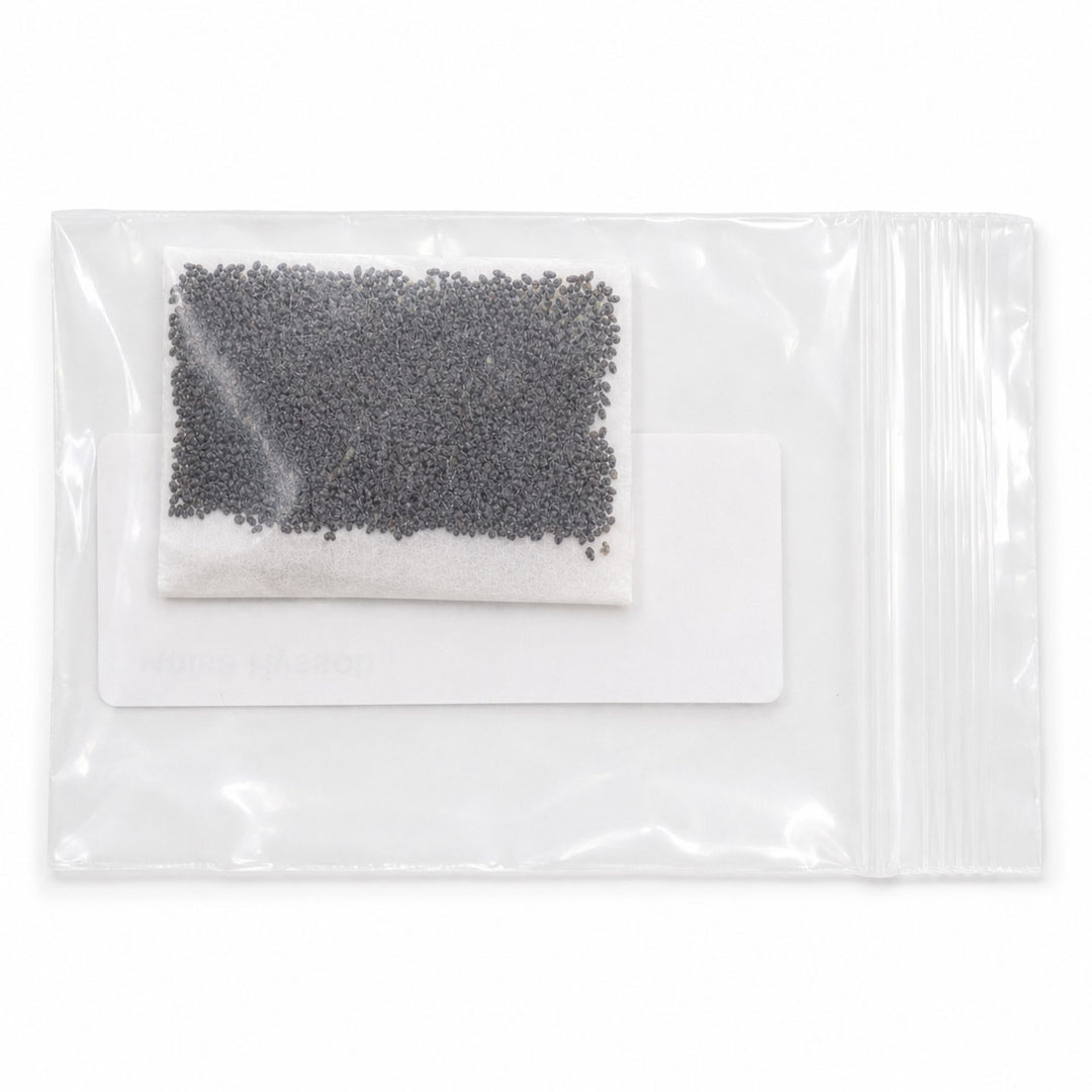 Clear plastic package with black beads and a white cloth inside on a white background