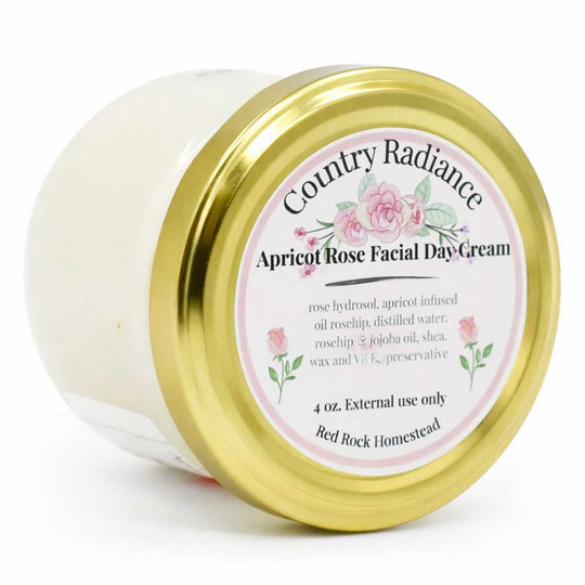 Jar of Country Radiance Apricot Rose Facial Day Cream with a gold lid on a white background