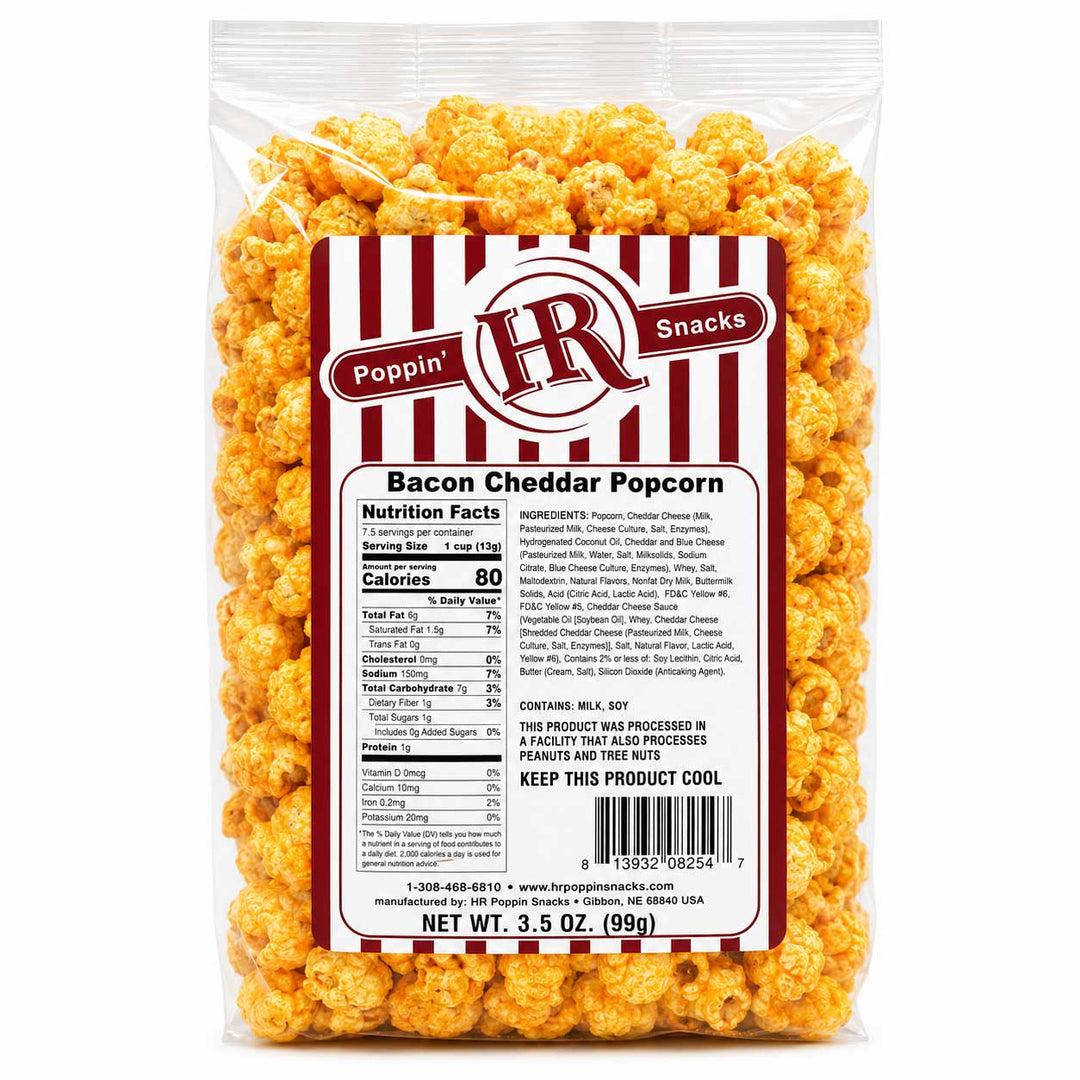 A 3.5 oz bag of Poppin' HR Bacon Cheddar Popcorn, showing the golden-orange cheese-flavored popcorn through a clear plastic bag with a white and red striped label.