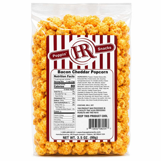 A 3.5 oz bag of Poppin' HR Bacon Cheddar Popcorn, showing the golden-orange cheese-flavored popcorn through a clear plastic bag with a white and red striped label.