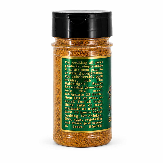 A clear plastic bottle of Rub Jim Baldwin's Secret Seasoning filled with orange-brown ground spice, topped with a black flip-top lid, and shown against a plain white background.