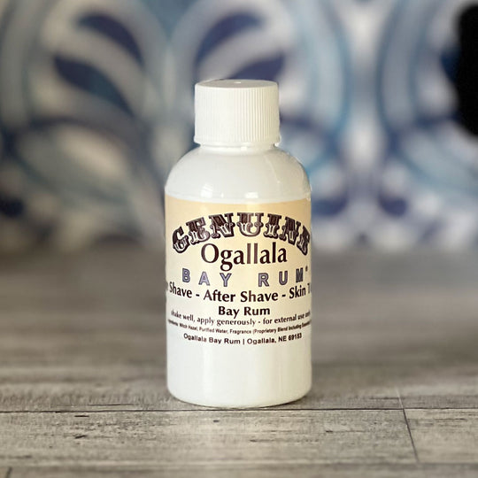 Ogallala Bay Rum bottle on a wooden surface with a blurred background