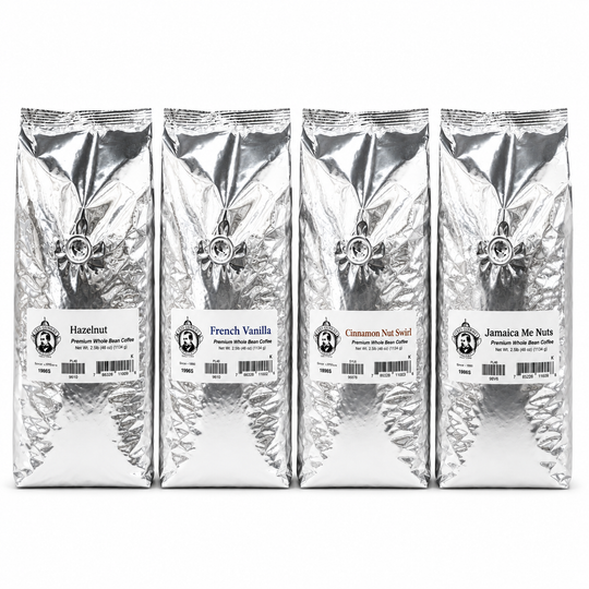 Four silver coffee bags with different flavors on a white background