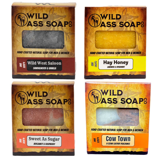 Four boxes of Wild Ass Soap with different scents on a white background