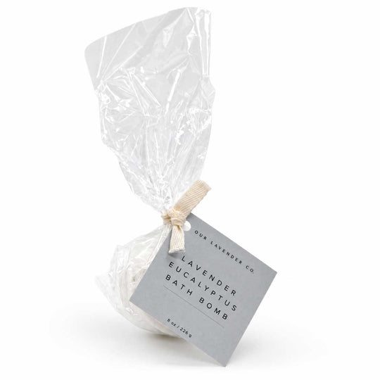 Lavender Eucalyptus bath bomb in clear plastic packaging with a label on a white background