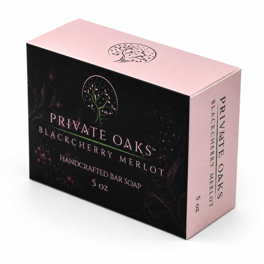 A 5 oz box of Private Oaks Blackberry Merlot Handcrafted Bar Soap. The packaging features a black front panel with dark berry illustrations and a light pink top and side panel, with the brand name and product name clearly printed.
