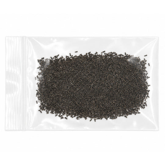 Small black beads in a clear plastic bag on a white background