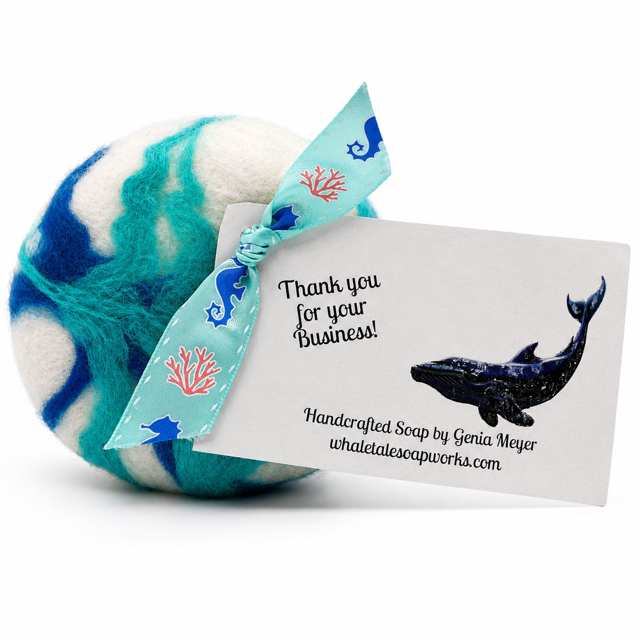 Handcrafted soap with a whale-themed label on a white background