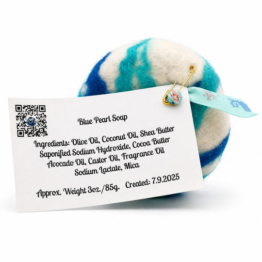 Blue and white striped soap with a label detailing ingredients on a white background