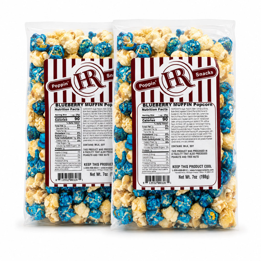 Two clear plastic bags of Poppin' Blueberry Muffin Popcorn with red-and-white striped labels, shown on a plain white background.