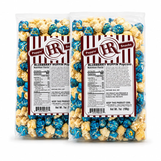 Two clear plastic bags of Poppin' Blueberry Muffin Popcorn with red-and-white striped labels, shown on a plain white background.