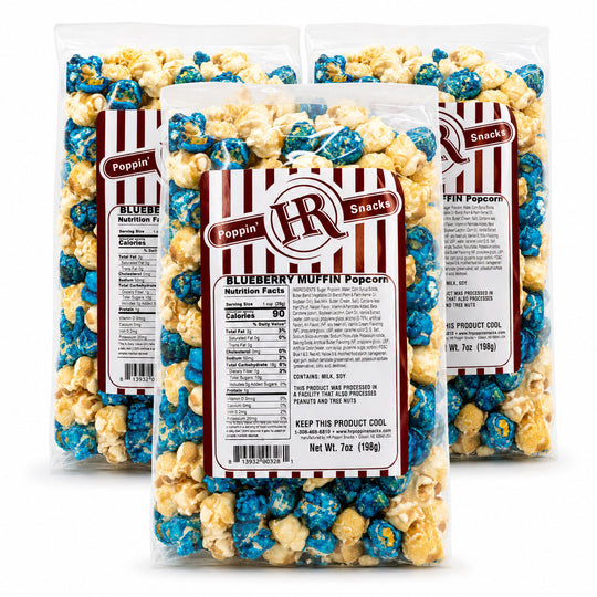 Three clear bags of Poppin' HR Blueberry Muffin Popcorn arranged in a fan shape on a white background, showing the blue and yellow popcorn inside along with the front label.