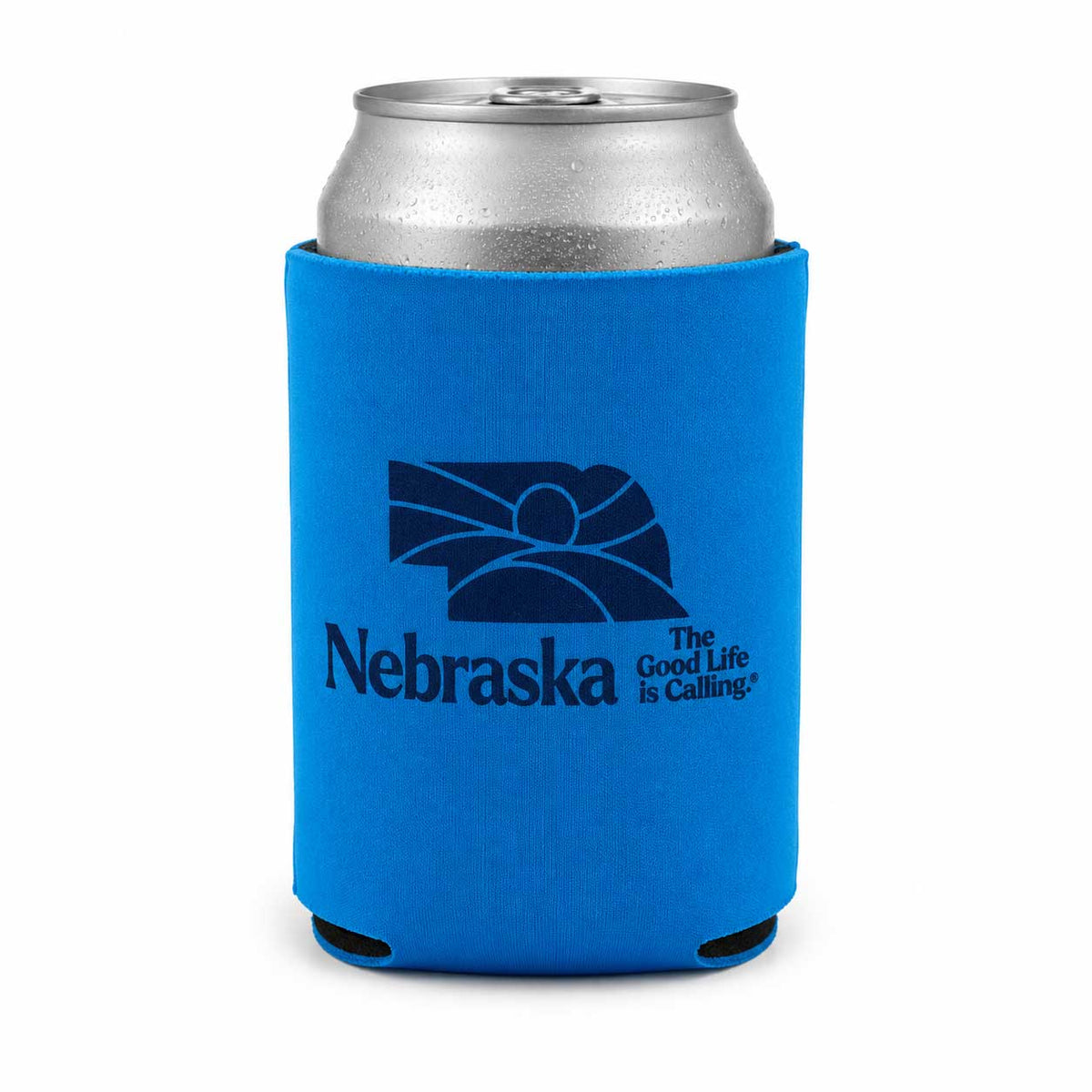 A bright blue neoprene can cooler sleeve with a dark blue Nebraska state graphic and the text 'Nebraska The Good Life is Calling' on a white background, holding a silver aluminum can.