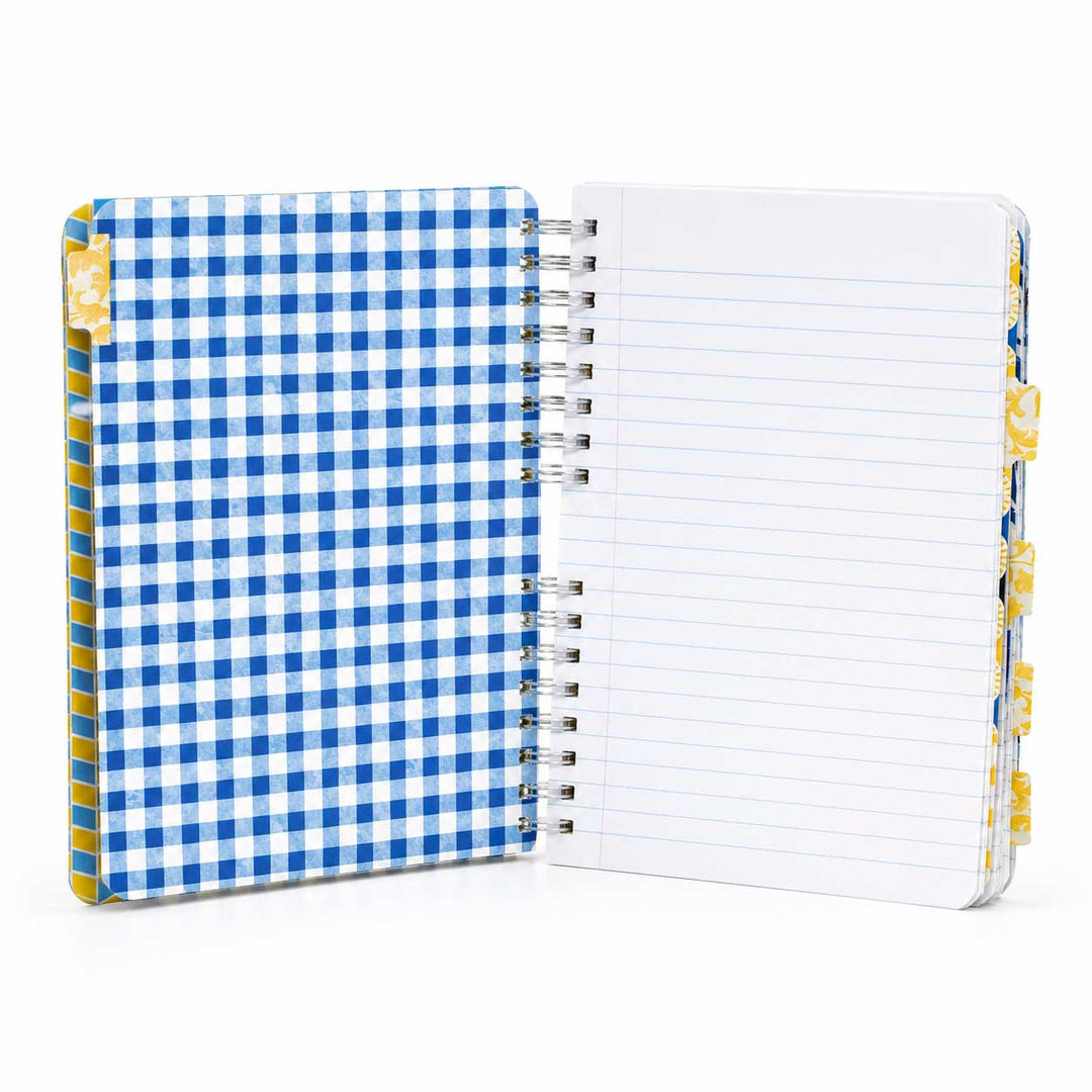 A spiral-bound notebook with a blue and white gingham patterned cover, shown open to reveal lined white pages on the right side.