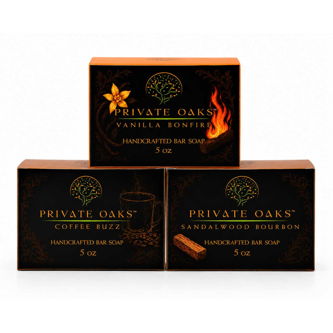Three boxes of Private Oaks Handcrafted Bar Soap arranged in a pyramid on a white background. The top box is Vanilla Bonfire, and the bottom two boxes are Coffee Buzz and Sandalwood Bourbon, each 5 oz.