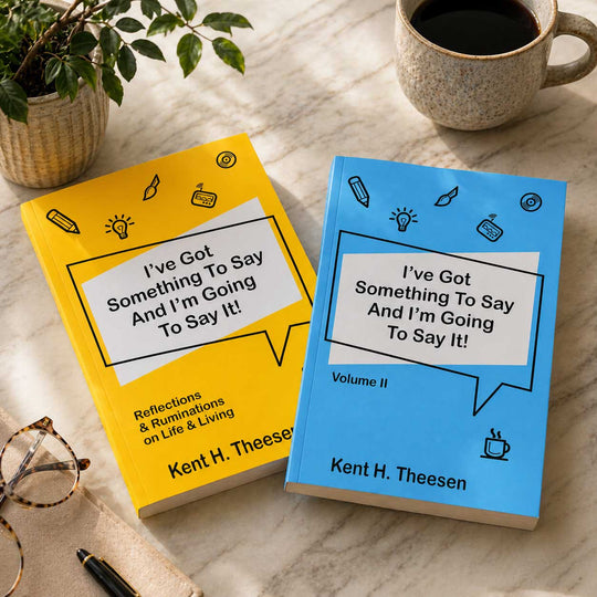 Two books titled 'I've Got Something To Say And I'm Going To Say It!' by Kent H. Theesen on a marble surface with a cup of coffee and glasses.