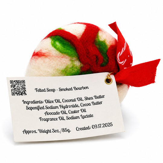 Felted soap with a red and green pattern and a label on a white background
