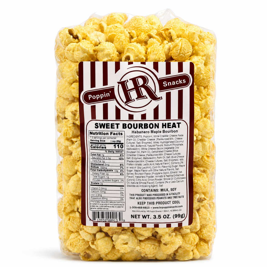A clear plastic bag filled with yellow popcorn and wrapped in a white and dark red striped label that reads 'Poppin' Snacks' and 'Sweet Bourbon Heat'.