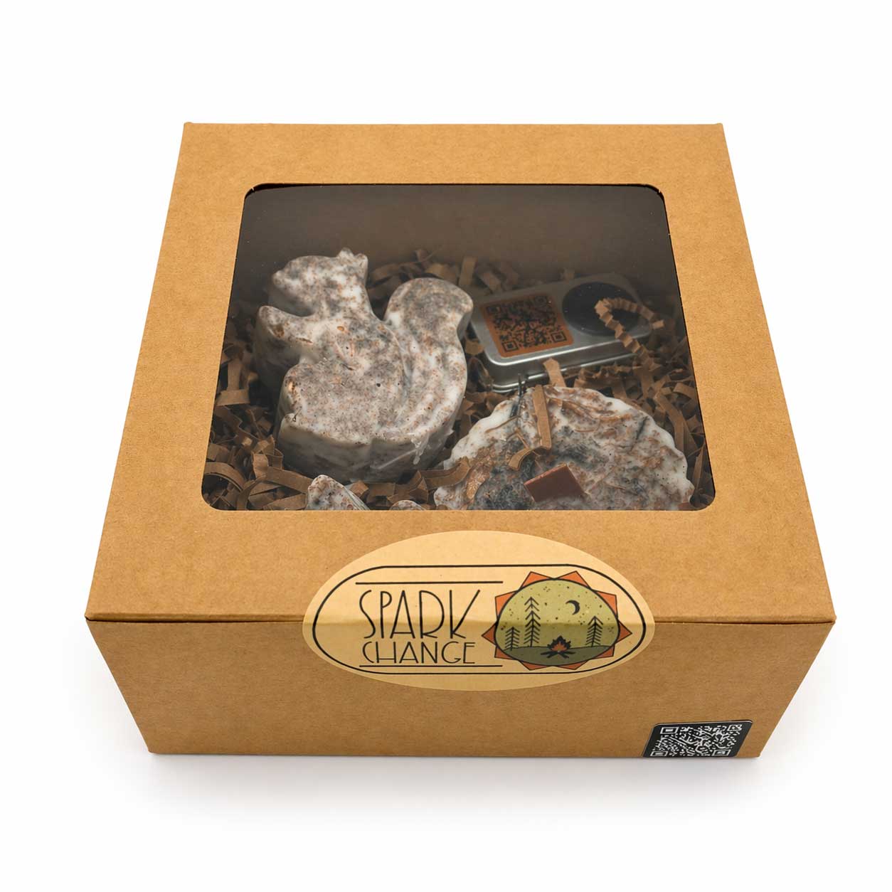Box with a clear window containing fire starters and a small metal box, branded 'Spark change'