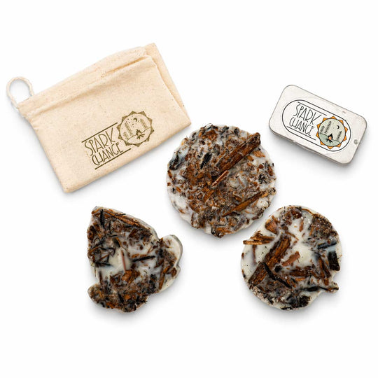 Three fire starters with a pouch and tin labeled 'spark change' on a white background
