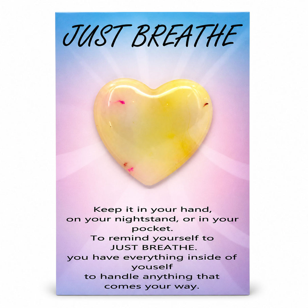 Heart-shaped object with 'Just Breathe' text on a colorful background