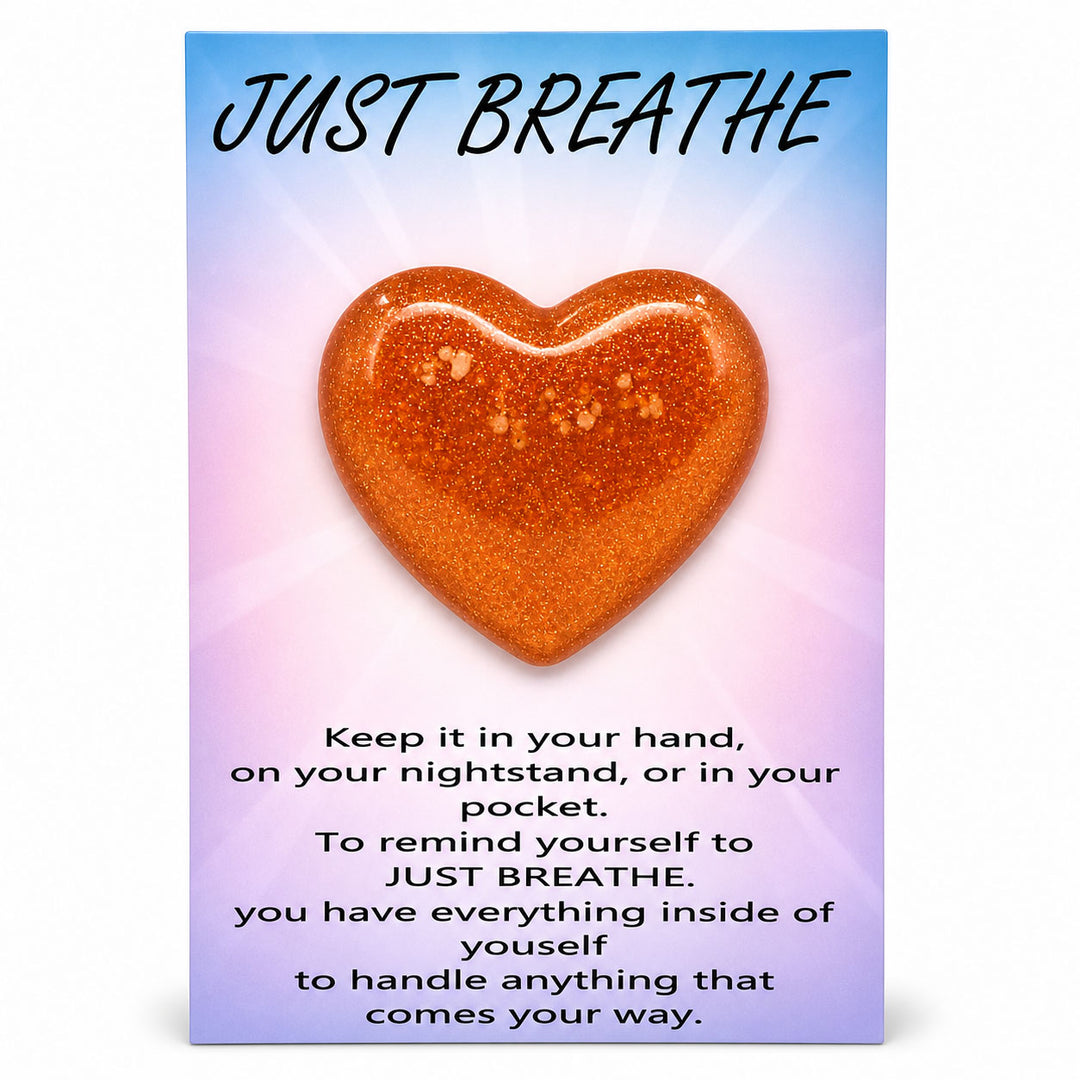 Heart-shaped object with 'Just Breathe' text on a gradient background