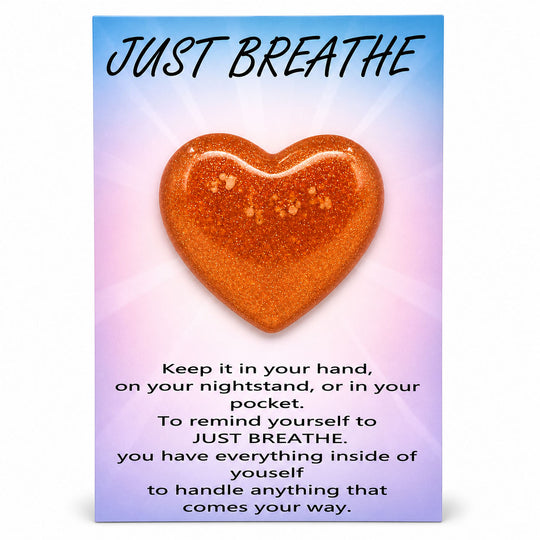 Heart-shaped object with 'Just Breathe' text on a gradient background