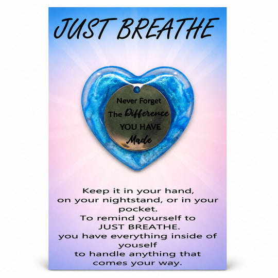 Blue heart-shaped pendant with motivational message on a gradient background