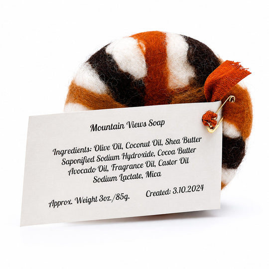 Striped soap with a label detailing ingredients and creation date on a white background