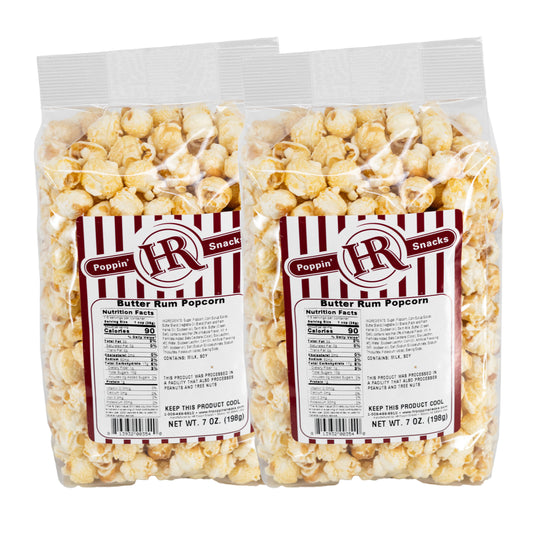 Two packages of HR Poppin' Snacks Butter Rum Popcorn on a white background