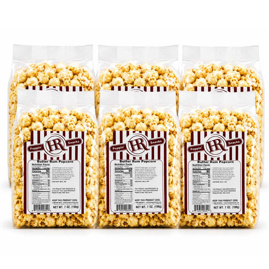 Six bags of  HR Poppin Snacks butter rum popcorn arranged in two rows of three on a white background.