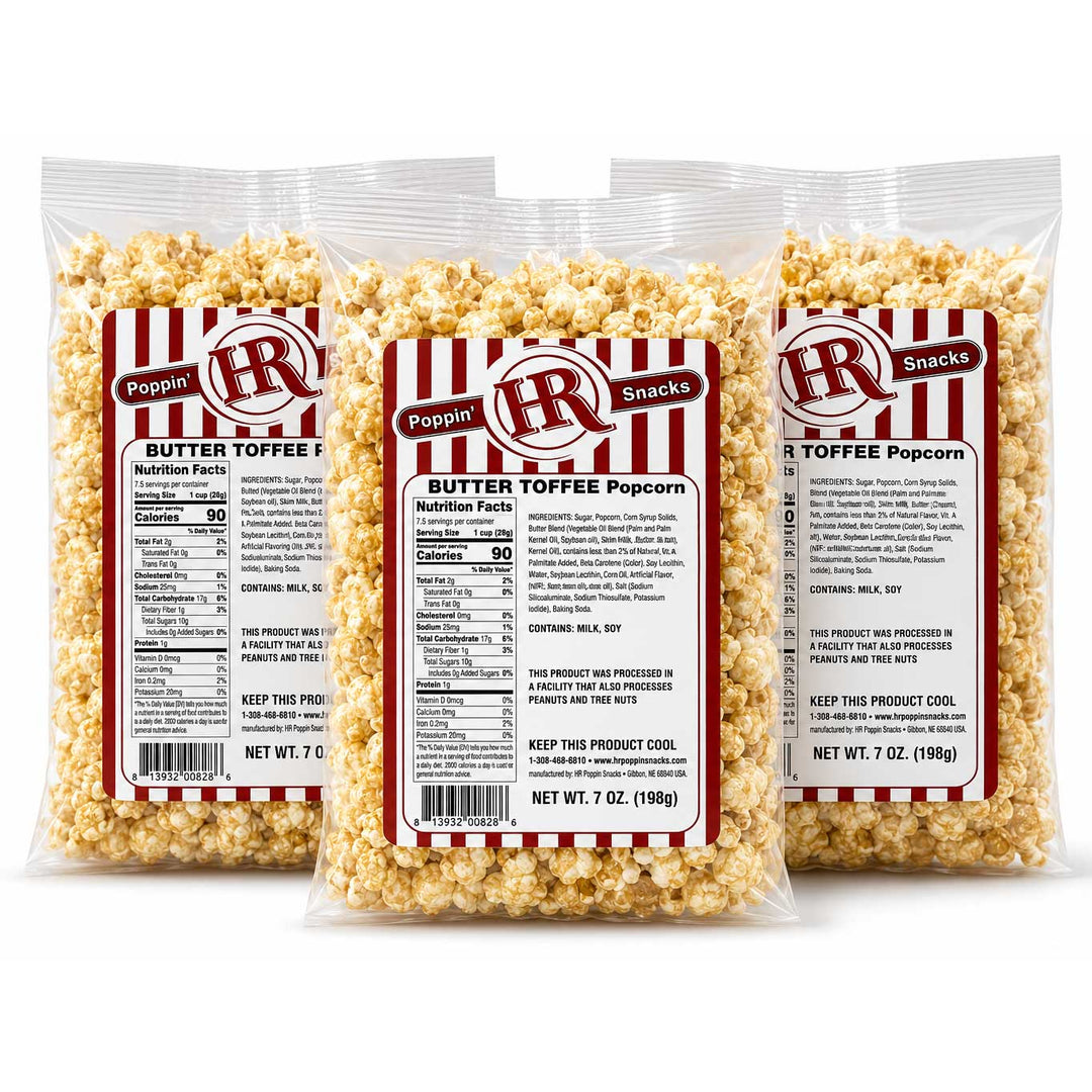 Three clear plastic bags of butter toffee popcorn arranged in a fan shape on a white background. The bags have red and white striped labels with the brand logo 'H&R' and text reading 'Poptop' and 'Butter Toffee Popcorn'.