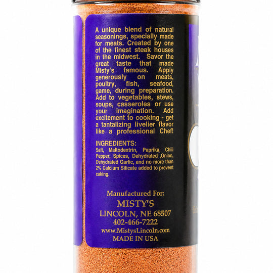 Spice container with purple label and orange spice mix on a white background