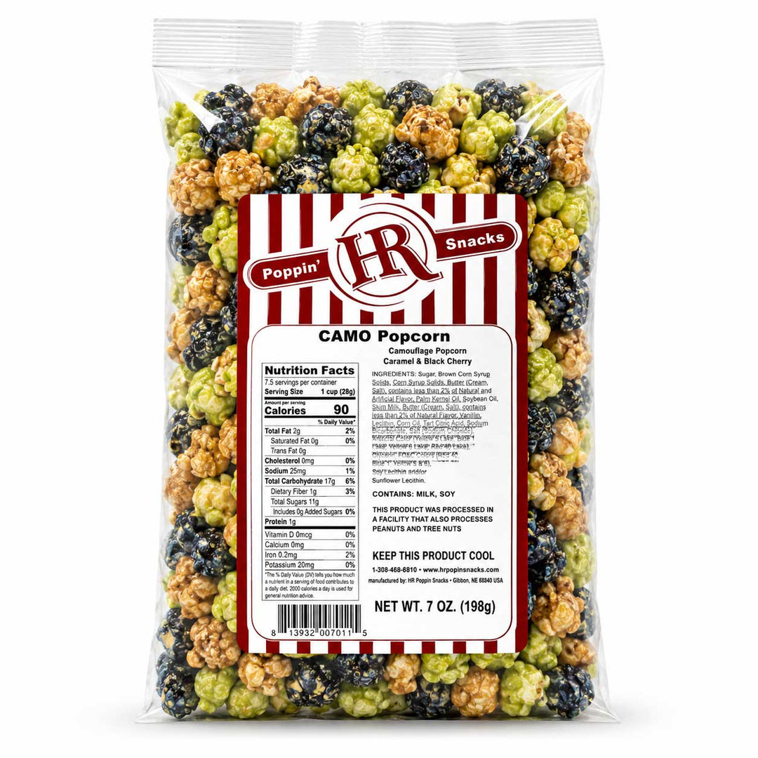 A 7 oz bag of Poppin' HR Snacks Camo Popcorn in caramel and black cherry flavors, showing a mix of green, beige, and dark purple popcorn pieces visible through a clear bag with a white and red label.