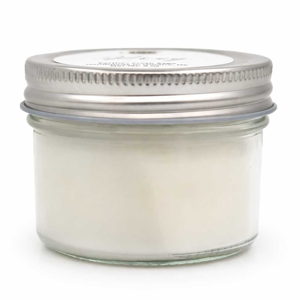 Glass jar with metal lid on a white background