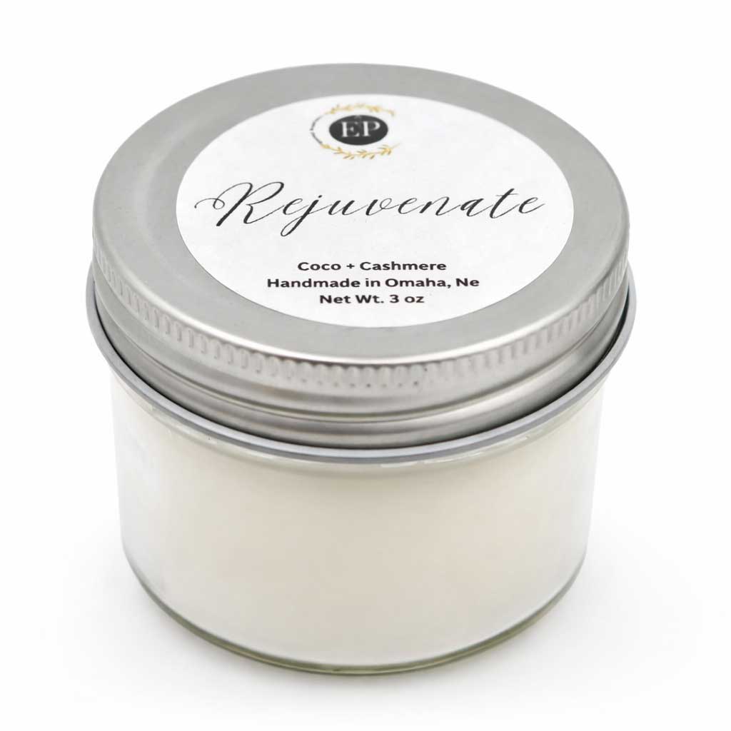Candle jar labeled 'Rejuvenate' with a silver lid on a white background