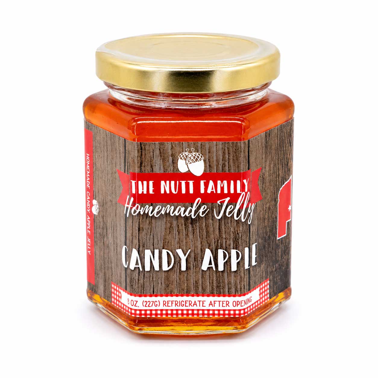 Jar of candy apple jelly with a wooden label on a white background