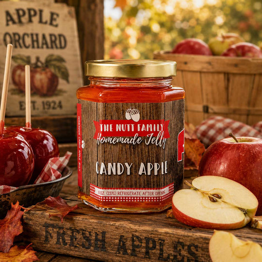Jar of 'The Nutt Family Homemade Jelly Candy Apple' with apples and a sign in the background